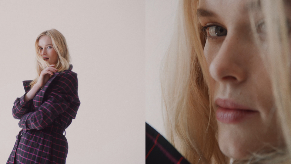 blonde female model facing the camera wearing a coat