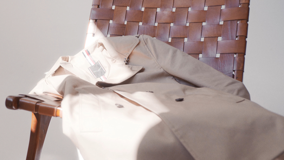 light creamy coat on brown leather chair