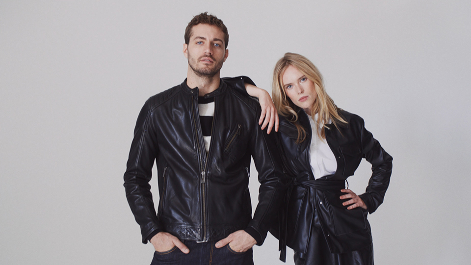 blonde female model leaning on male short-haired model looking casually into the camera