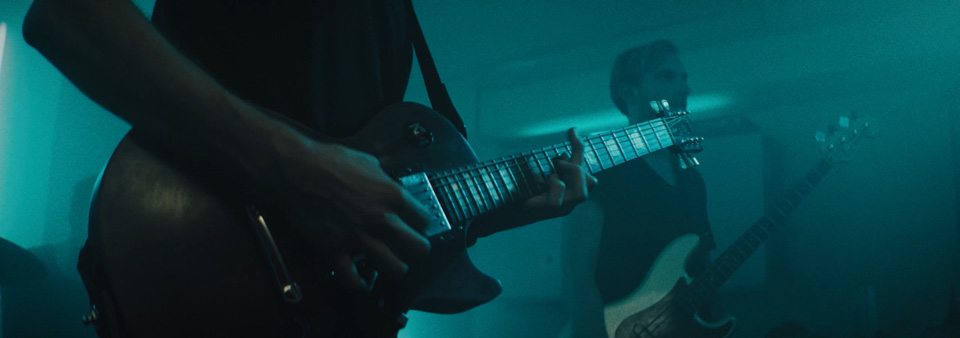 close up shot of hands playing a guitar